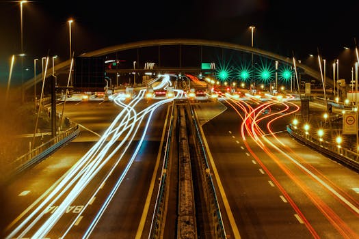 Night view of Lendinara's urban streets with vibrant car light trails, illuminating the city's dynamic movement.